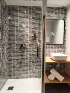 a bathroom with a shower and a sink at Hôtel Restaurant Logis La Méridienne in Anglards-de-Saint-Flour +41 photos