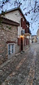 a stone building on a cobblestone street at Aπανεμα Ανδ συγγρου 34 in Galaxidi +10 photos