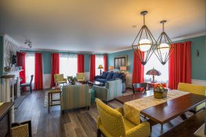 a living room with red curtains and a dining room at Saybrook Point Resort & Marina in Old Saybrook