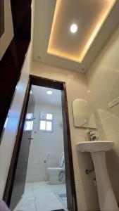 a bathroom with a shower and a sink and a toilet at المبيت 2 جديد in Abha +17 photos