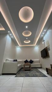 a living room with a couch and a table at المبيت 2 جديد in Abha