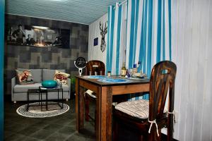 a kitchen with a table and two chairs and a couch at Casa Alba in Mastershausen
