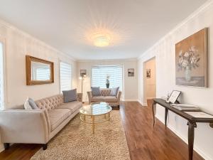 a living room with a couch and a table at The Promenade Cottage License # 002-2023 in Niagara-on-the-Lake