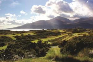a view of a golf course with mountains in the background at The Dundrum Inn B&B in Dundrum