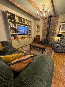 a living room with a couch and a tv at The Dundrum Inn B&B in Dundrum