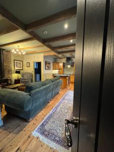a living room with a couch and a kitchen at The Dundrum Inn B&B in Dundrum