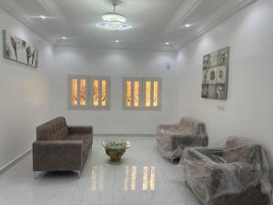 a living room with two chairs and a couch at Omega Apparts A2 in Rufisque