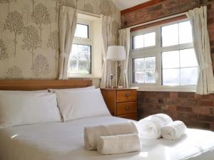 a bedroom with a bed with towels on it at Brown Snout in Ledbury