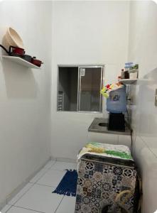 a white room with a table and a window at São Francisco Aparts in Salvador
