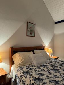a bed in a room with two tables and two lamps at Quinta dos Faisões in Santo Antônio do Pinhal