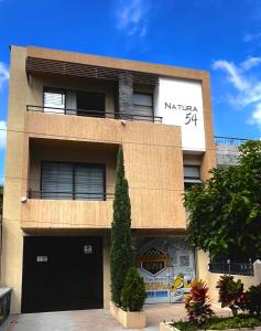a building with a sign on the side of it at 202 Apartaestudio Edificio Natura 54, cercano Centro Comerciales in Ibagué