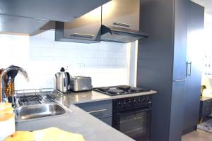 a kitchen with a sink and a stove at Lynwood Circa 209 in Pretoria