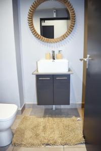 a bathroom with a sink and a mirror at Lynwood Circa 209 in Pretoria