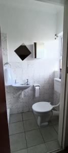 a white bathroom with a toilet and a sink at Accomodation in Cape Town in Goodwood +23 photos