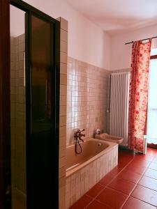 a bathroom with a bath tub and a shower at B&B il Baciass in Pinerolo +22 photos