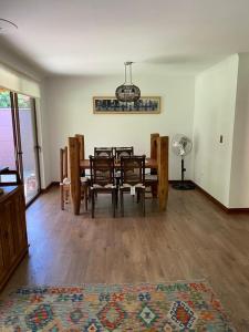 a dining room with a table and chairs in a room at Casa del Parque in Talca