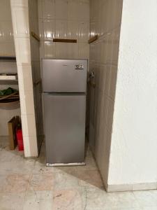 a refrigerator in the corner of a kitchen at House in Monterrey Nuevo León in Monterrey