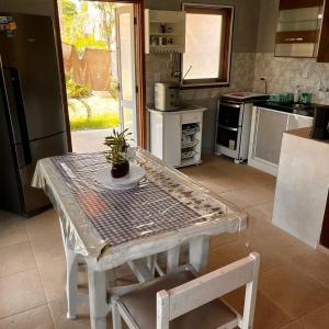 a kitchen with a table with a potted plant on it at Casa in Baia Formosa-Bùzios in Búzios
