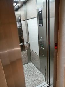 a elevator with a glass door in a building at Aria lux Titova vila in Zlatibor