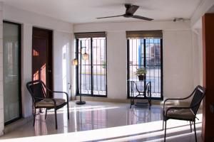 a living room with two chairs and a table at Hotel Posada del Angel in Mérida