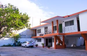 a white car parked in front of a building at Hotel Posada del Angel in Mérida