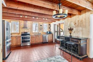 a large kitchen with wooden walls and a ceiling at Strathmere Country Retreat in Ottawa