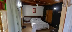 a bedroom with a bed and a mirror in a room at Na Petko suite in Gaiman