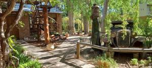 a garden with an old fire hydrant and trees at Na Petko suite in Gaiman