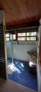 a room with a table and a blue tile floor at Na Petko suite in Gaiman
