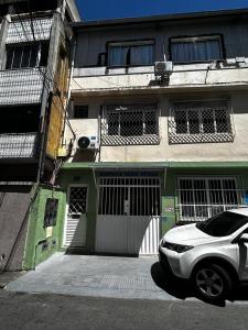 a white car parked in front of a building at Apartamento 1 quarto, sala e cozinha próximo ao Aeroporto in Vitória