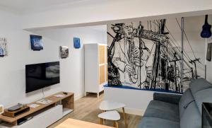 a living room with a drawing on the wall at Studio Music Blue - Bourgoin Centre in Bourgoin