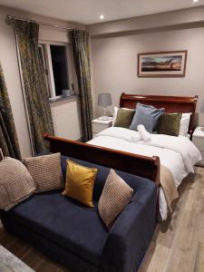 a bedroom with a large bed and a couch at The Snook-Free Parking-Near Pentland Hills in Loanhead