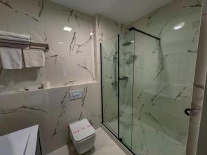 a bathroom with a glass shower and a toilet at Vila Bomond in Edineţ