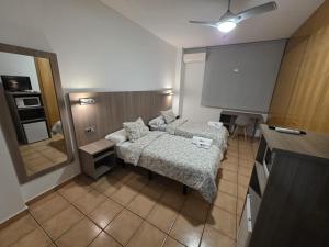 a small room with a bed and a mirror at Hostal De la Rosa by Parque Warner Madrid in Valdemoro