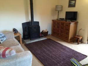 a living room with a fireplace and a couch at Gibraltar Farm Cottage in Hebden Bridge