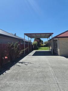 awning over a driveway between two buildings at Private Ensuite Room in Rolleston