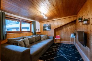 a living room with a couch and a tv at Haus Tisch in Schruns
