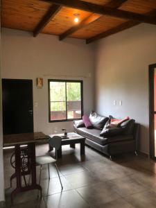 a living room with a couch and a flat screen tv at Casa roja in Eldorado