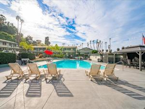 a group of chairs sitting around a swimming pool at The Atwood Hotel San Diego - SeaWorld/Zoo in San Diego