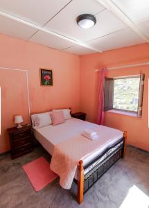 a bedroom with a bed and a window at Quinta Toca do leão in Ribeira Grande +49 photos
