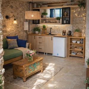 a kitchen and living room with a couch and a table at FİNTOZ BUTİKA New in Karaburun