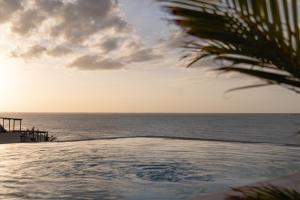 a view of the ocean from a swimming pool at Casa Astral Hotel Boutique and Apartments in Holbox Island