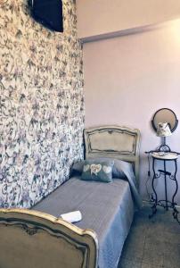 a bedroom with a bed and a wall with flowers at Love Gioia Tauro in Gioia Tauro