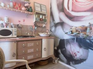 a kitchen with a large painting on the wall at Love Gioia Tauro in Gioia Tauro