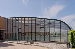 a large glass building with a curved roof at Apartamentos turísticos Sardon in Sardón de los Frailes