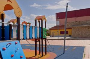 a playground in a school with a slide at Apartamentos turísticos Sardon in Sardón de los Frailes