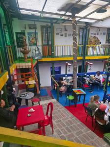 a group of people sitting in a play room at Hostal Gastro Bar Casa Colibrí in Bogotá