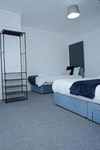 a bedroom with two beds and a mirror at Contractor & Family Haven, Sleeps 7, Parking & Garden in Wednesfield