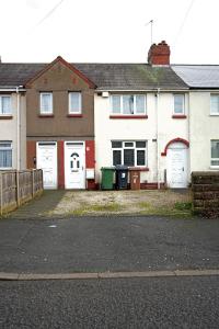 a group of houses with white doors and a fence at Contractor & Family Haven, Sleeps 7, Parking & Garden in Wednesfield