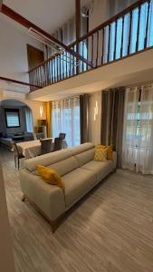 a large living room with a couch and a staircase at VILLA TOMILLARES in Los Tomillares